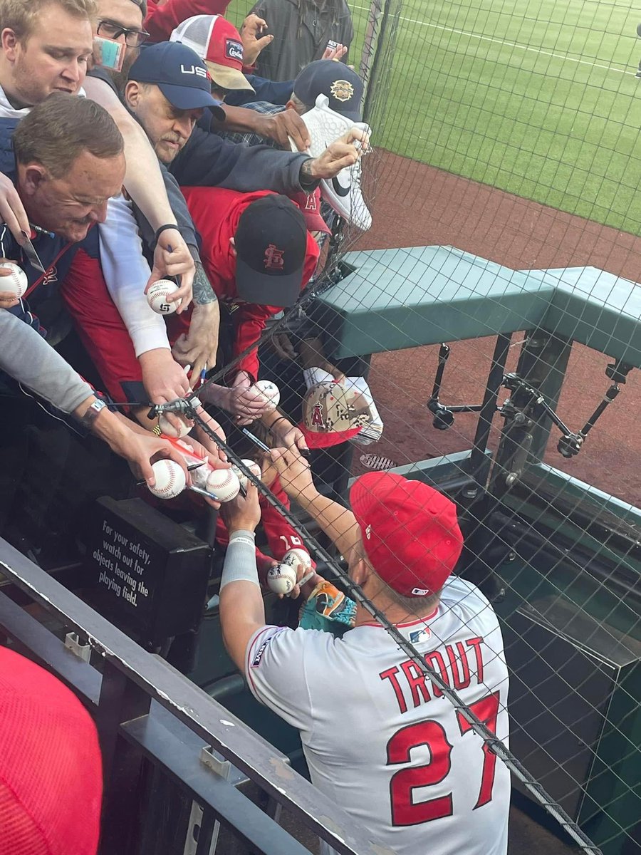 My 8yo son in the first picture with a huge smile on his face when he saw his favorite player <a href="/MikeTrout/">Mike Trout</a> enter the dugout…next picture you literally cannot even see him because of all of the grown men smashing him trying to get an autograph. <a href="/MLB/">MLB</a> needs to fix this!!