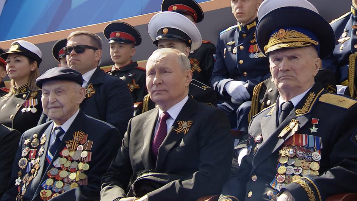 It’s very interesting to see who Putin chose to sit next to during the Victory Day parade. The two men next to him in this photo may have been presented as WW2 veterans, but neither served in that war at all. But if they are not WW2 veterans, who are they? 1/6