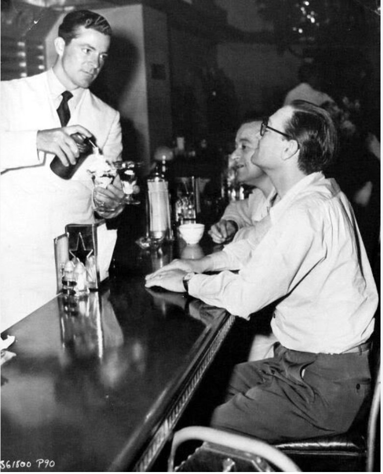 On the set of #TheBestYearsOfOurLives: #DanaAndrews practices his sundae-making skills as DP #GreggToland and #WilliamWyler monitor the whipped cream allocation. #TCMParty #drugstorecowboy