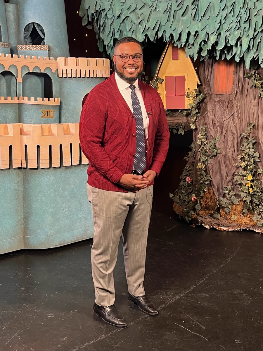 Lt. Gov. Austin Davis, wearing a red cardigan on a television set