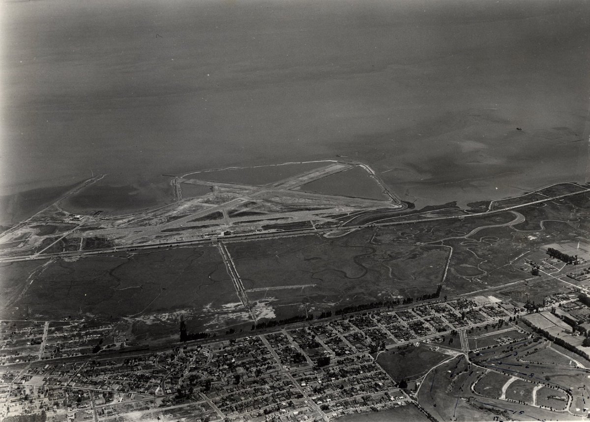 SFOMuseum's tweet photo. What did @flySFO look like #onthisday in 1940? The 1937 Terminal and Hangars 1-4 are visible, as are the runways. Beginning in 1935 as part of FDR’s New Deal, runway “C” was extended from 1,900 to 3,000 feet. (The runways now measure 7,650 and 11,870 feet!) #SFOHistory #AvGeek https://t.co/6AopavWfF6