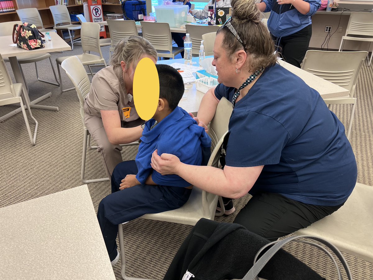 Nurse Casey is a trusted friend <a href="/WellingtonElem/">Wellington Elementary</a>. She's helping with a vaccine clinic at her school &amp; supports one of her students while they get a shot. Immunizations keep children well &amp; in school. Thanks Casey for all you do! #NursesWeek2023