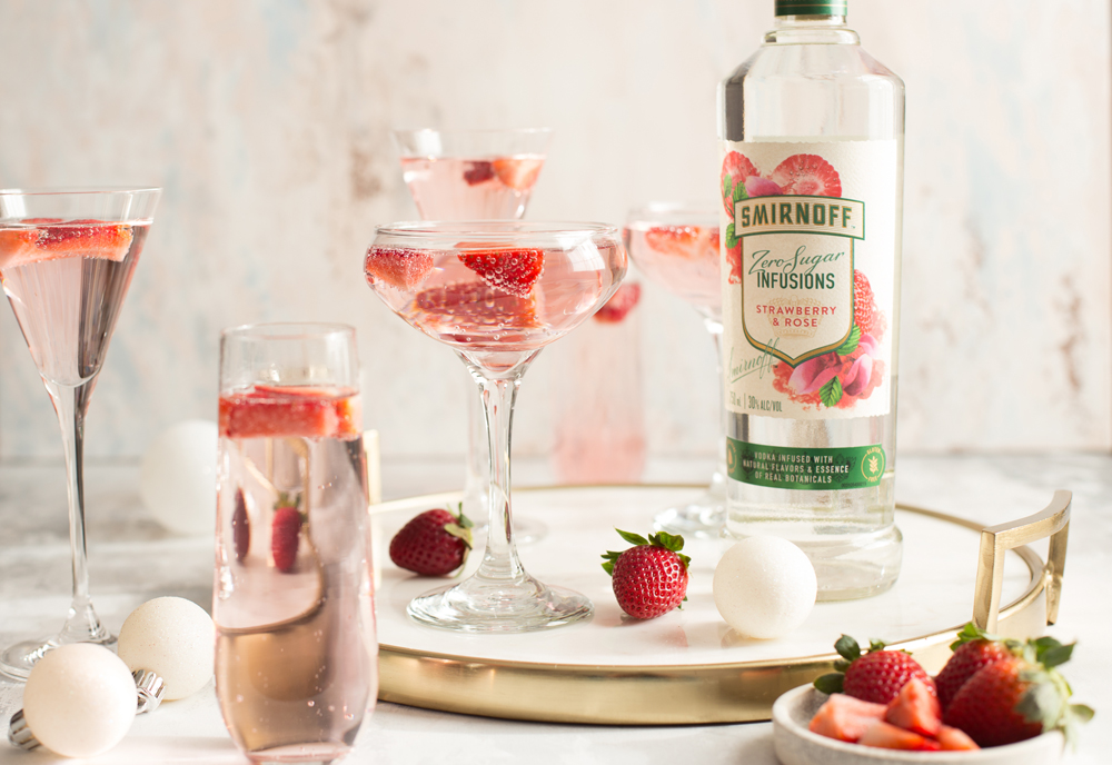 Smirnoff Zero Sugar Infusions Strawberry &amp; Rose is infused with strawberry flavor with a light rose petal finish and goes perfectly with a splash of soda and ice and a rose petal garnish. 🍓