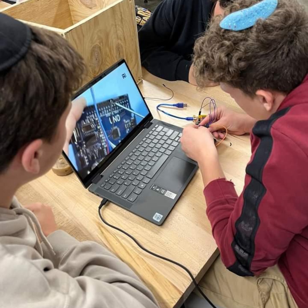 CIJETech's tweet photo. Students at HAFTR are working hard on their prototype of a self-opening cabinet for Innovation Day 👏👏👏

You can see them here connecting a button to a servo (which they later ditched for a potentiometer) and getting their gesture sensor wired. Good luck, team! 🥳 #CIJEinAction https://t.co/pOL1ZM9vJF