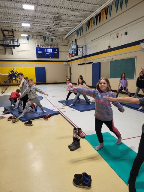 Fitweek Fun at Malden Central!  Mindful stretches in the gym at nutrition break.
