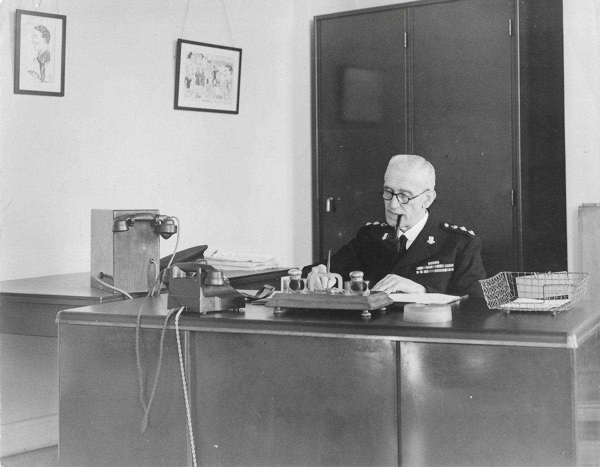 The pipe-smoking ACC A.E. Martin (Devon Constabulary), c1938. He was the last officer in the force to hold the rank of sergeant major when the rank was abolished in 1928. Must've had a sense of humour, because he has a caricature of his boss hanging on the wall! #PoliceHistory