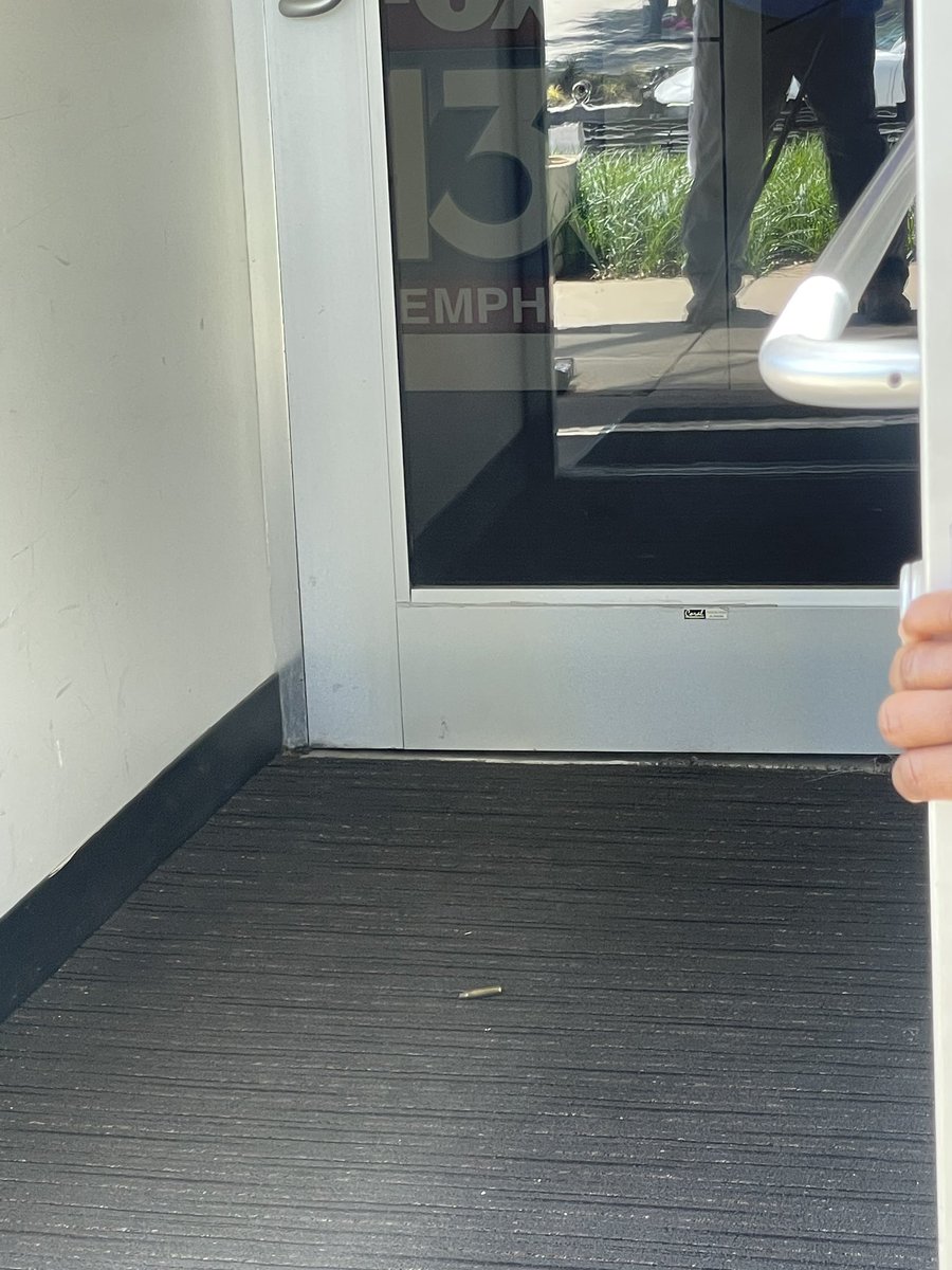 SheliaOConnor's tweet photo. A guy fired shots towards our station this morning. You can see the bullet hole in the picture. He’s currently locked himself inside a nearby business. No employees or staff members were hit or injured @FOX13Memphis https://t.co/Z4egWSW0sG