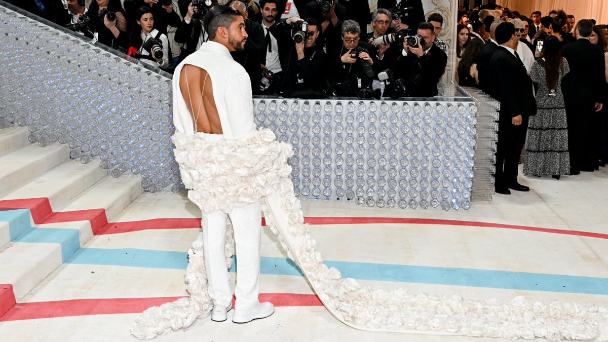 outmagazine's tweet photo. Baby got back! 

#BadBunny (@sanbenito) brought sexy back in a custom suit from queer designer Simon Porte @jacquemus at last night's #MetGala, and we have to say, the backs were definitely backin'! 

😍 https://t.co/tTm3X1lOTD