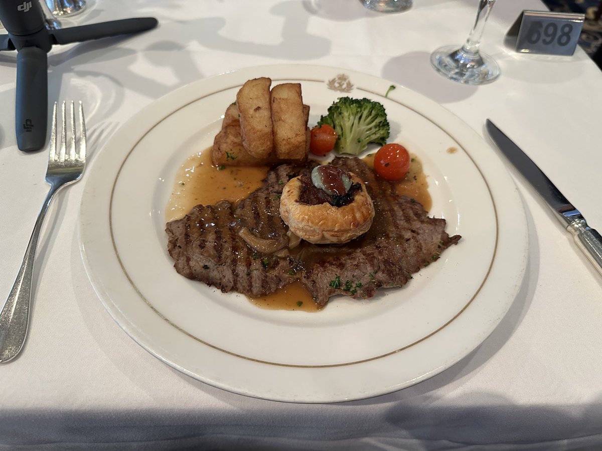 DaftCatTravel's tweet photo. Dinner on the Queen Mary 2 was lovely. That chocolate marquise was out of this world. Now getting a cognac in Sir Samuel’s before the theatre and the waiter brought a couple of nibbles whilst we’re waiting on the drinks. #QM2 #QueenMary2 #Cunard https://t.co/OmuBZsrCBN