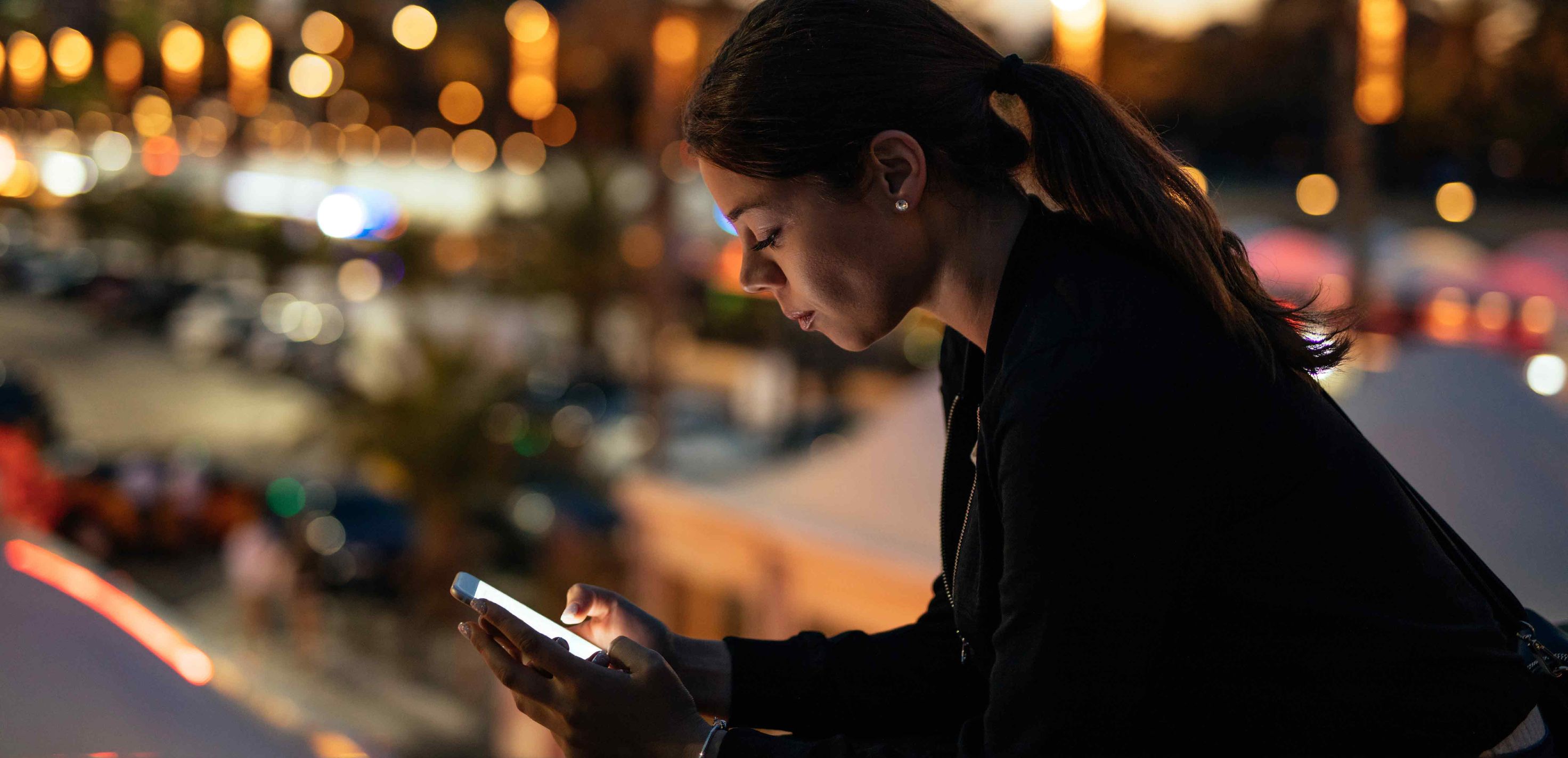Girl with Phone at Night