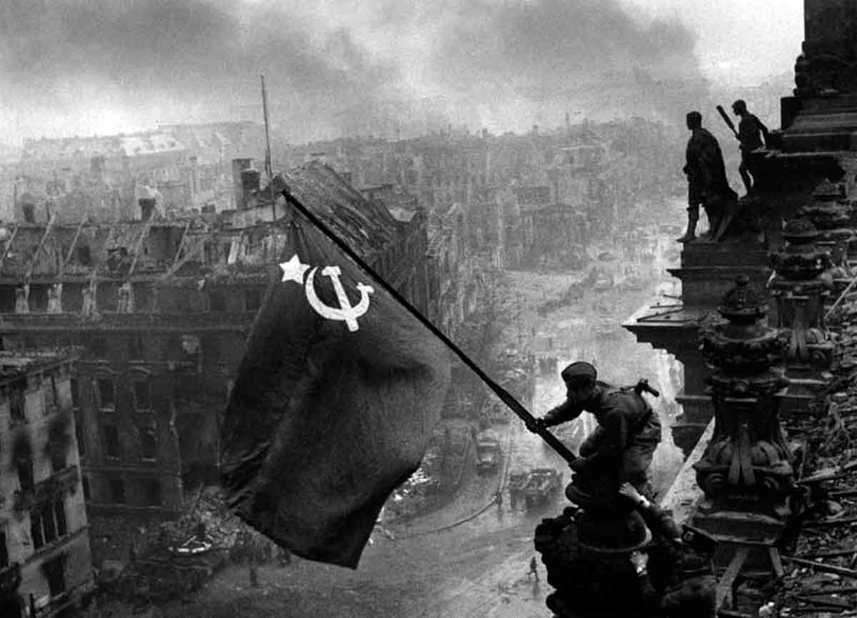 After three days of brutal room-to-room combat in Berlin's Reichstag, Red Army troops hoist the Soviet Union's flag over the heart of the conquered German capital.