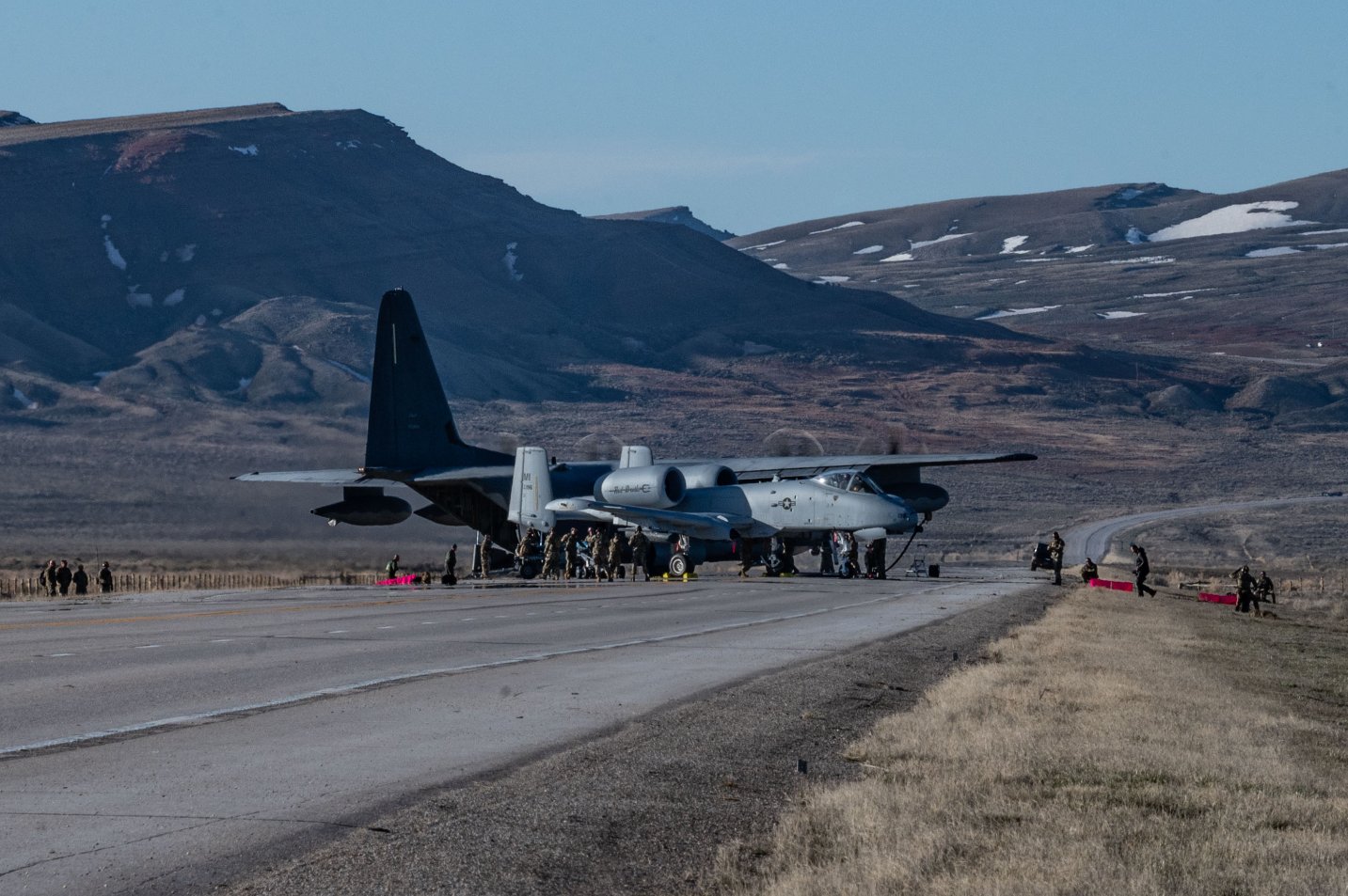 An MC-130J Commando II offloads fuel to an A-10 Thunderbolt II on Highway 287 during Exercise Agile Chariot, April 30, 2023, honing capabilities linked to Agile Combat Employment. Instead of relying on large, fixed bases and infrastructure, ACE uses smaller, more dispersed locations and teams to rapidly move and support aircraft, pilots, and other personnel to wherever they are needed. There are millions of miles of public roads in the United States, including federal, state, and local roads – with Agile Combat Employment, including Forward Arming and Refueling Point (FARP) and Integrated Combat Turnarounds (ICT), it becomes millions of miles of public runways, when necessary. (U.S. Air Force photo by Tech. Sgt. Carly Kavish)