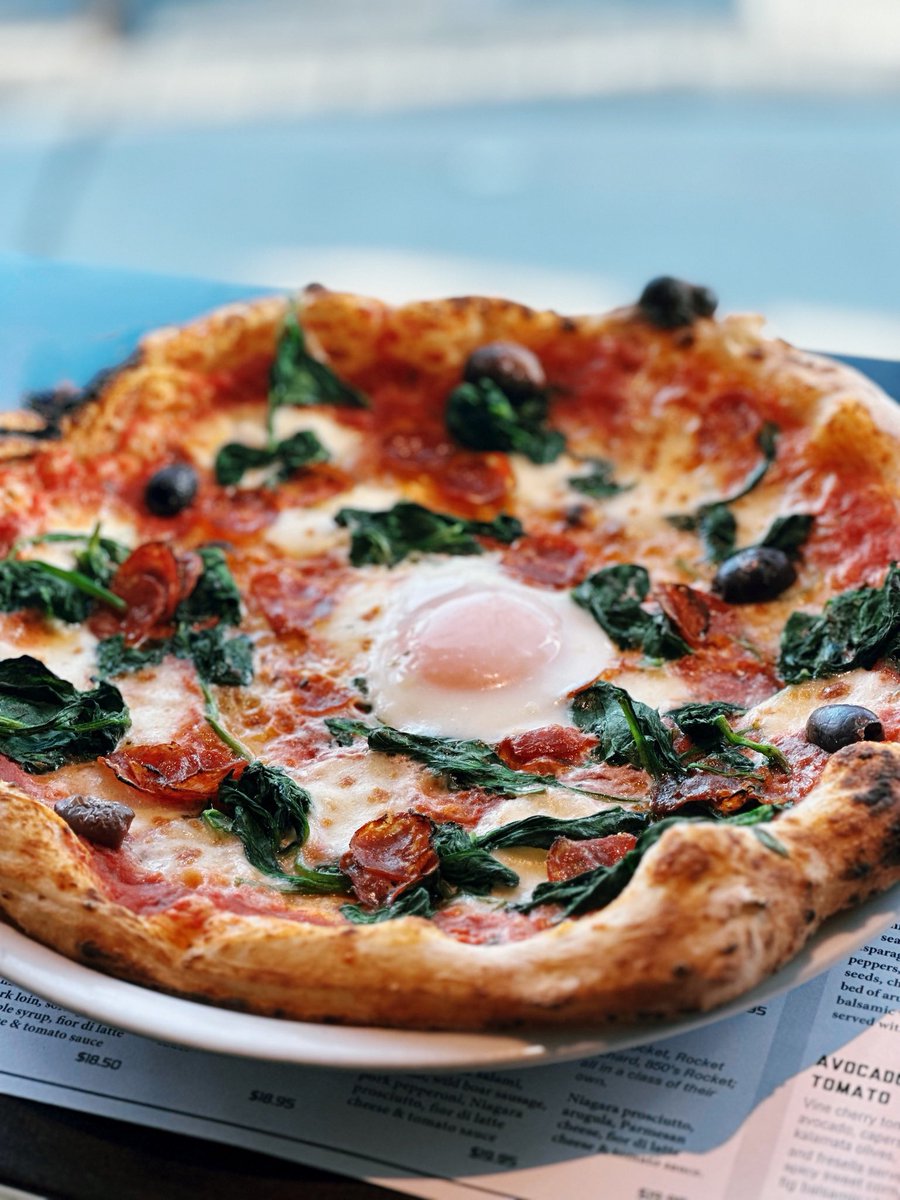 🍕 May's Pizza of the Month 🎉: Savor our mouth-watering creation, featuring tomato sauce, garlic sautéed spinach, kalamata olives, pepperoni &amp; mozzarella cheese, all topped with a soft duck egg! 🍅🌱🫒🍖🧀🥚 Don't miss out on this scrumptious delight! #PizzaOfTheMonth #Foodies