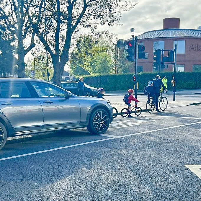 Two different ways to travel to school. 

Check out the size of the SUV compared to the children cycling. This is why we continue to campaign for active travel infrastructure. 

More people will make sustainable travel choices when the roads feel safe. #SafeRoadsForAll