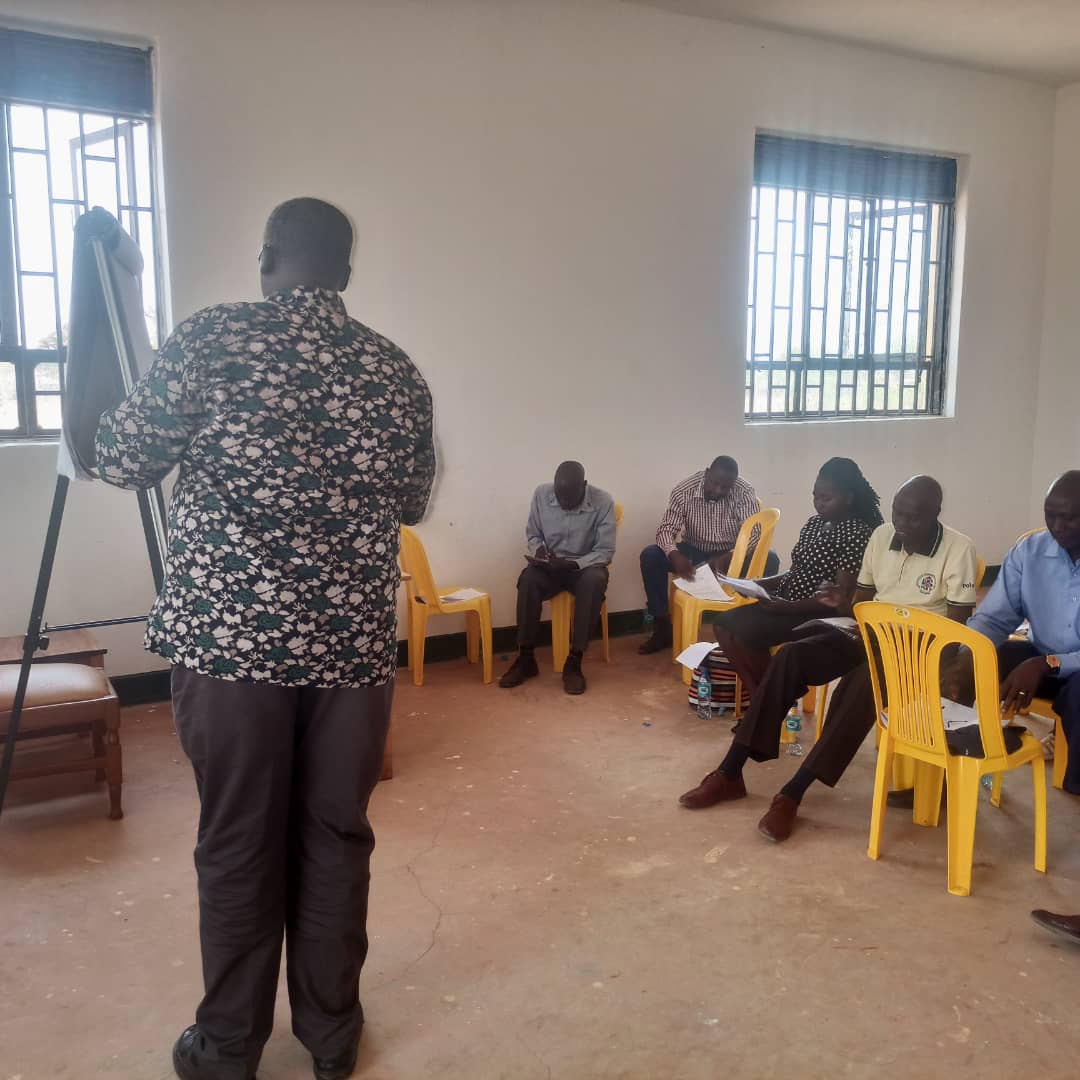 Al-Hajj Mustafa Ajuga facilitates financial reporting training at Sebei Farmers' Cooperative Society Limited, Chepskunya Town Council, Kween District.