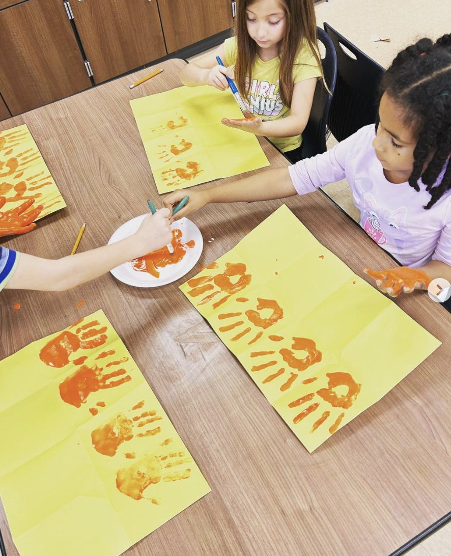 1st Grade using their hands as a printing tool!