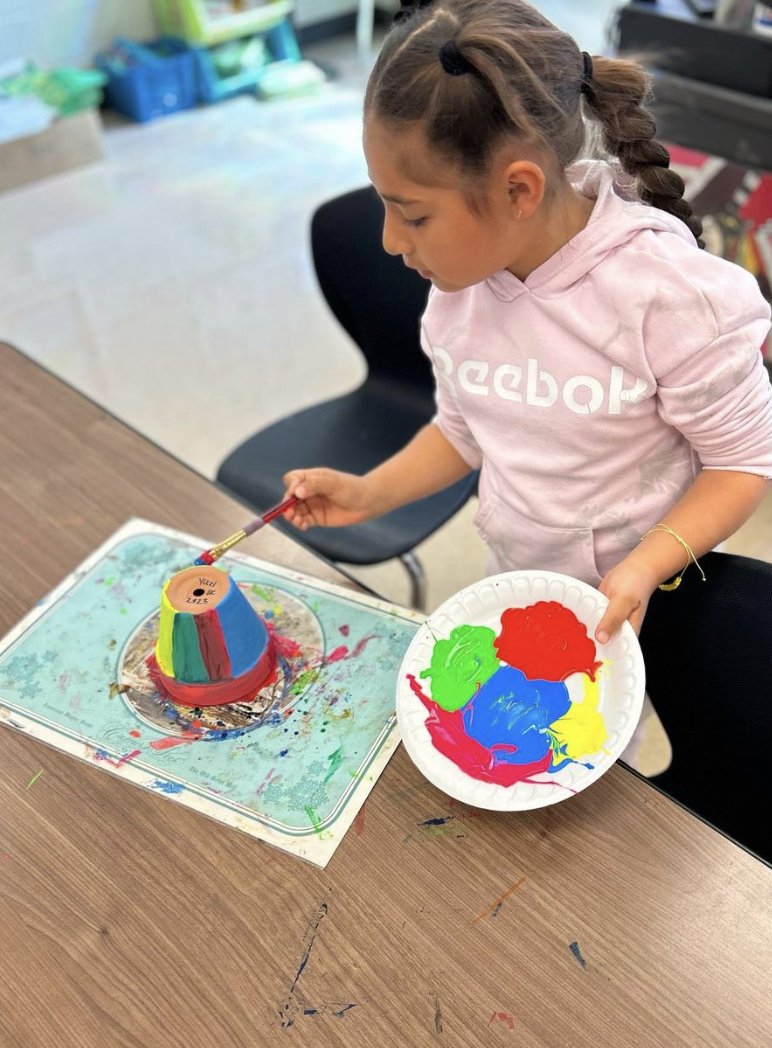 First Grader, Yucel, channeling her inner artist for Mothers Day Flower Pots!