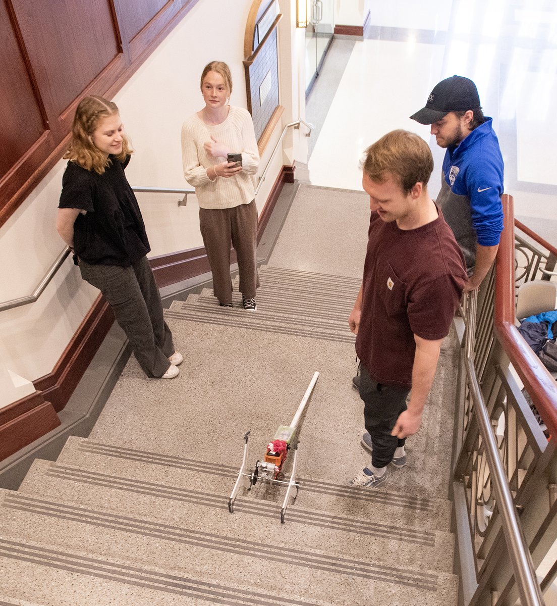 NDengineering's tweet photo. To encouraging cheers and applause, the student-designed robots in the Design Tools 2 class @NotreDame do their best to climb the stairs. https://t.co/q7VQKLt3bB