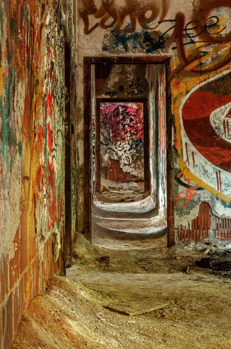 Drifts of asbestos in a long forgotten hallway inside an abandoned psychiatric hospital in New York.