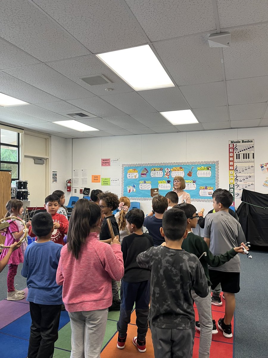 MsSlattum's tweet photo. We had fun singing and playing percussion instruments today! Retired volunteer teacher, Mrs. Ferkin leading room 5 @MadronaMustangs in all kinds of fun🎶 https://t.co/sT51ikwG9U