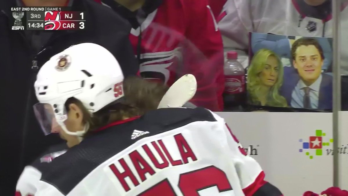 PeteBlackburn's tweet photo. Sebastian Aho photoshopped over a picture of Jack Hughes with his mom. Right behind the Devils bench. Incredible https://t.co/9DGO6gg9el