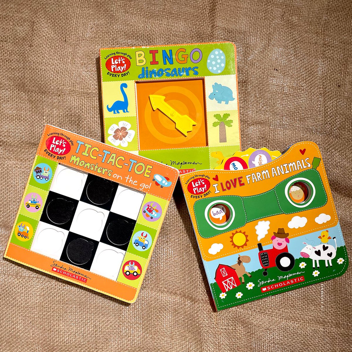 Scholastic's tweet photo. Check out the new Let's Play! series from Sandra Magsamen!

BINGO: DINOSAURS features a new bingo playing card on every page 🐱‍🐉
Play tic-tac-toe in TIC-TAC-TOE: MONSTERS ON THE GO 🚗
Match farm animals to the sounds they make in I LOVE FARM ANIMALS 🐄

https://t.co/89aX2HGSCp https://t.co/9QDWQBfchK