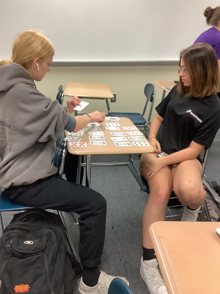 Taking a break : Students Kyra Chase and Kelsey Pross play cards during their math class!