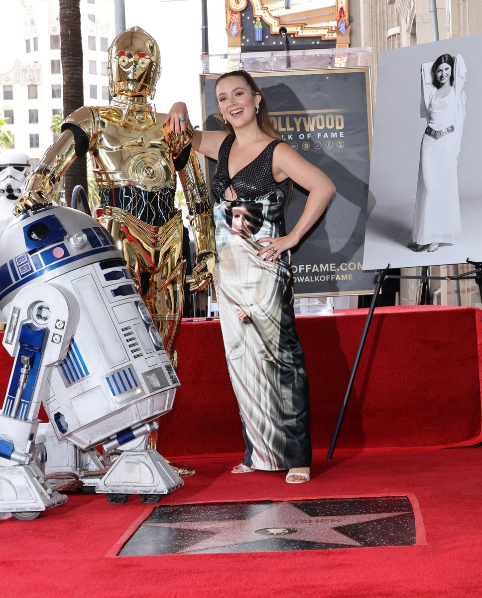 Variety's tweet photo. Billie Lourd, wearing a Princess Leia dress, poses with C-3PO and R2-D2 at Carrie Fisher's Hollywood Walk of Fame ceremony. https://t.co/WQh9RdX4RN https://t.co/LK8rqdDMsj