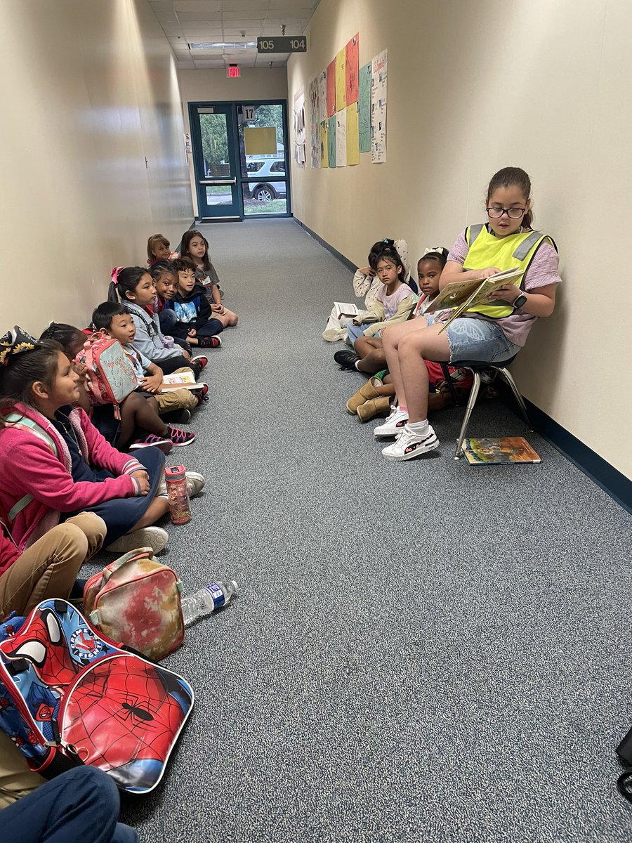 I spotted on my GALS showing her leadership skills 📖this morning while patrolling 🦺 the 1st Grade hallway! #girlsclub #leadership #safetypatrol