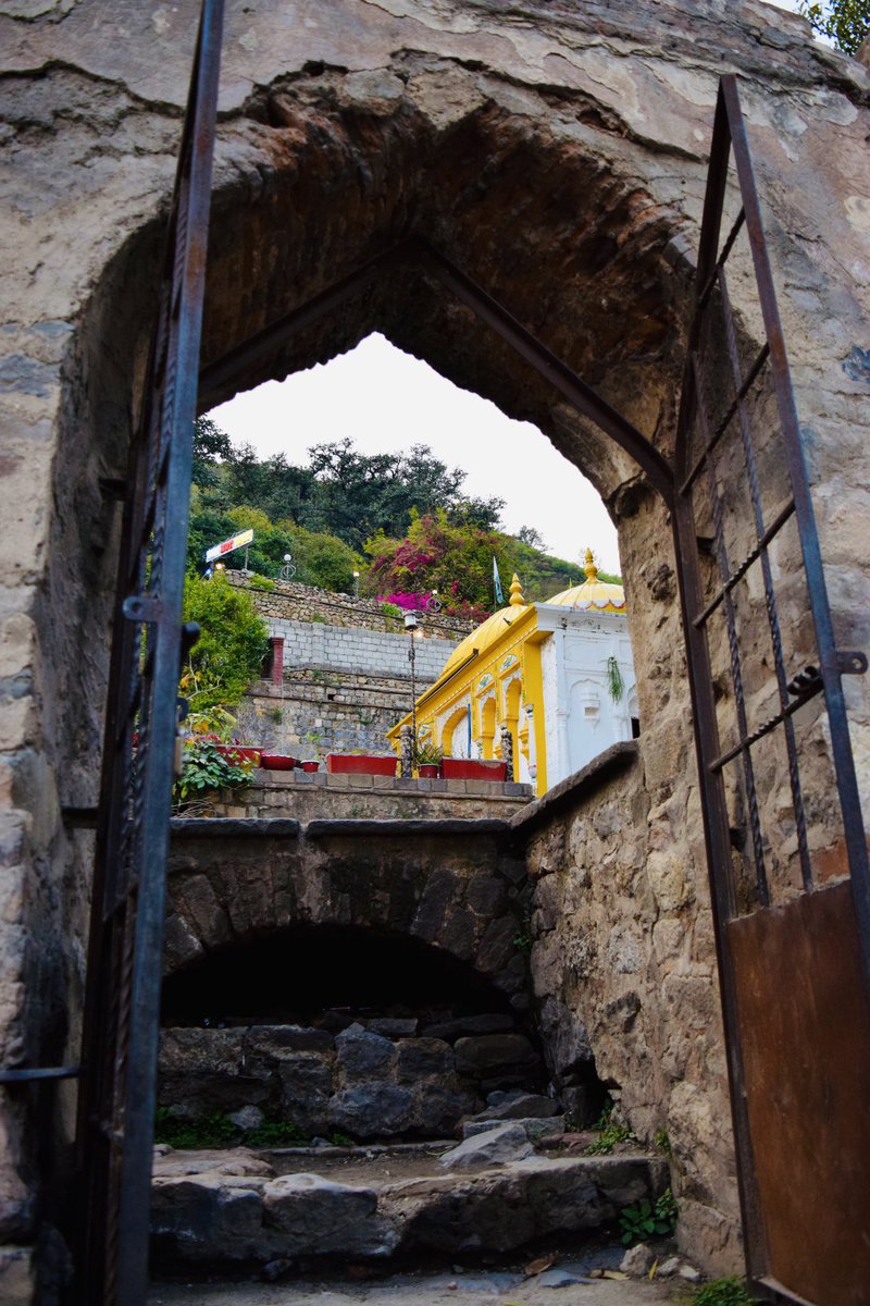 Gm everyone 💜🙌🏼🥳❤️

Here is “On The Other Side”, a shot from one of my favourite places in Islamabad, Pakistan. A place that helps me find my calm and peace every time. 
Through that door, you see one side of the 600 years old Gurdwara, still beautiful and standing 💜❤️🙌🏼
