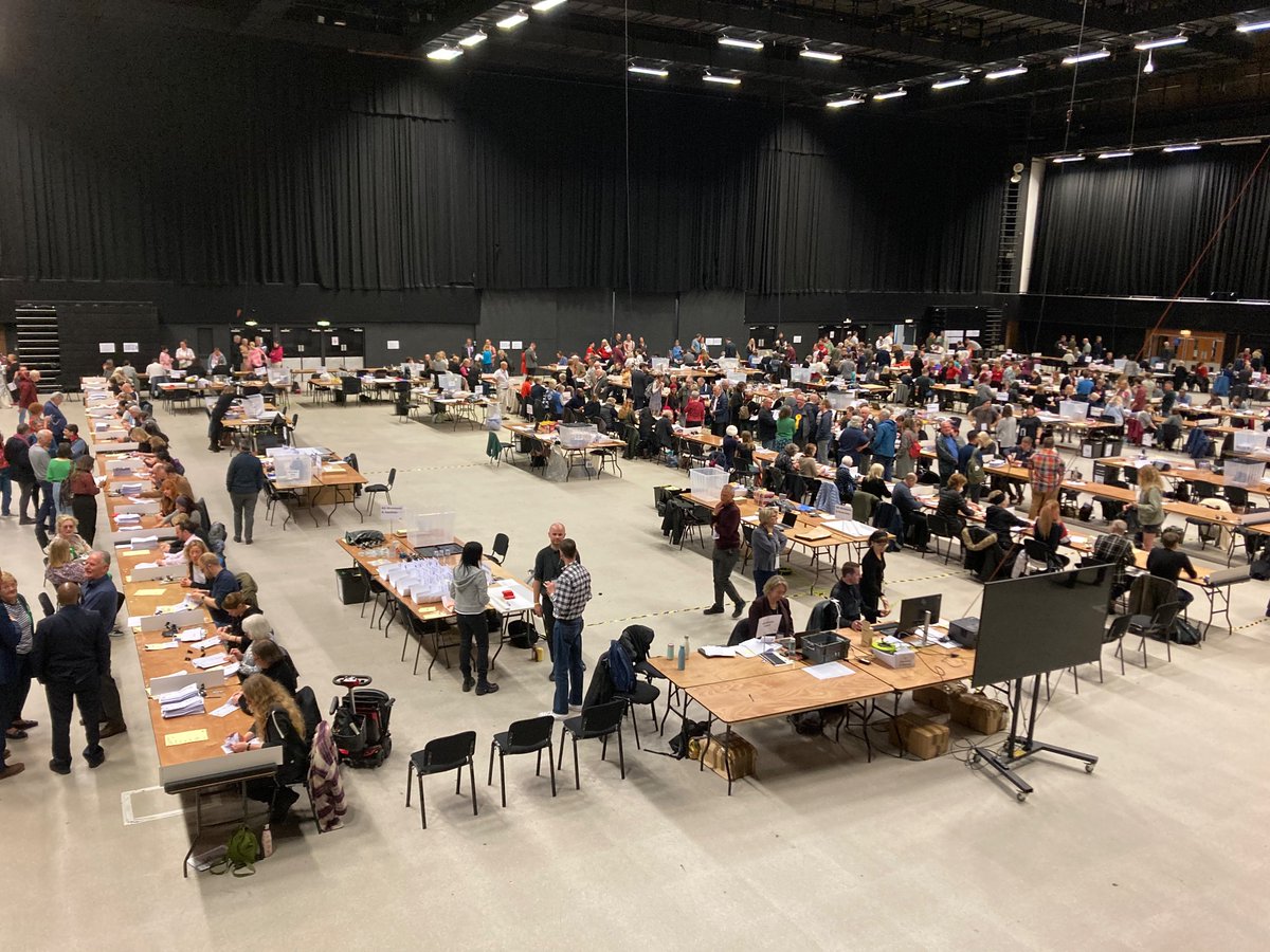 AJ_Dickenson's tweet photo. Count well underway in Brighton for #localelections, though first results not expected for a couple of hours - and final result possibly not until this evening. Plenty of Green and Labour support already walking the hall though as they duke it out on the ballot papers. https://t.co/e2i8PjjRnk