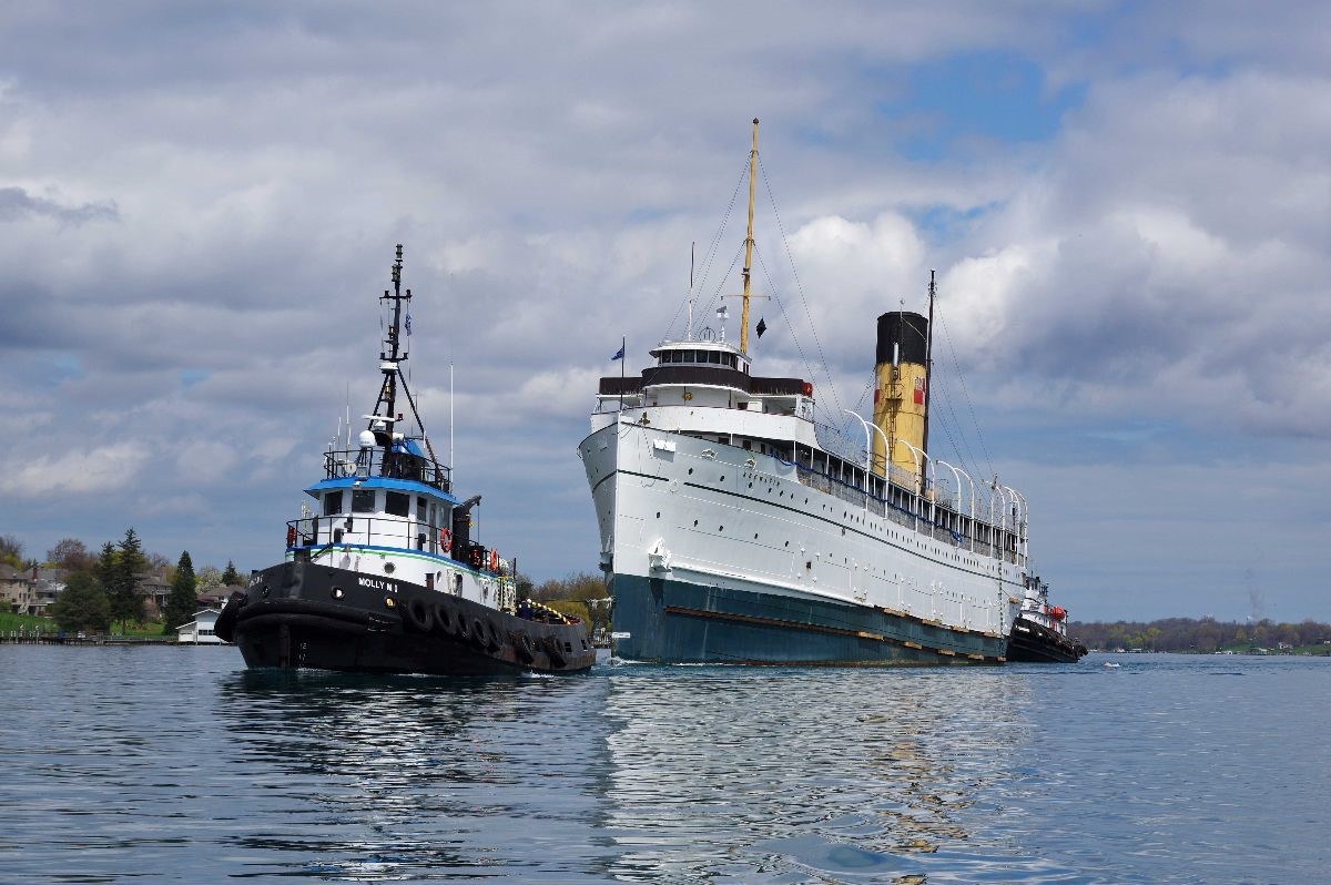 McKeilMarine's tweet photo. The S.S. Keewatin, an Edwardian-era steamliner older than the Titanic, arrived in Hamilton on April 29. Tugged by Molly M and Wyatt M, it drew large crowds on the transit route.  Now at Heddle Shipyard for restoration, it will eventually move to its permanent home in Kingston. https://t.co/KU6iRA8SxN