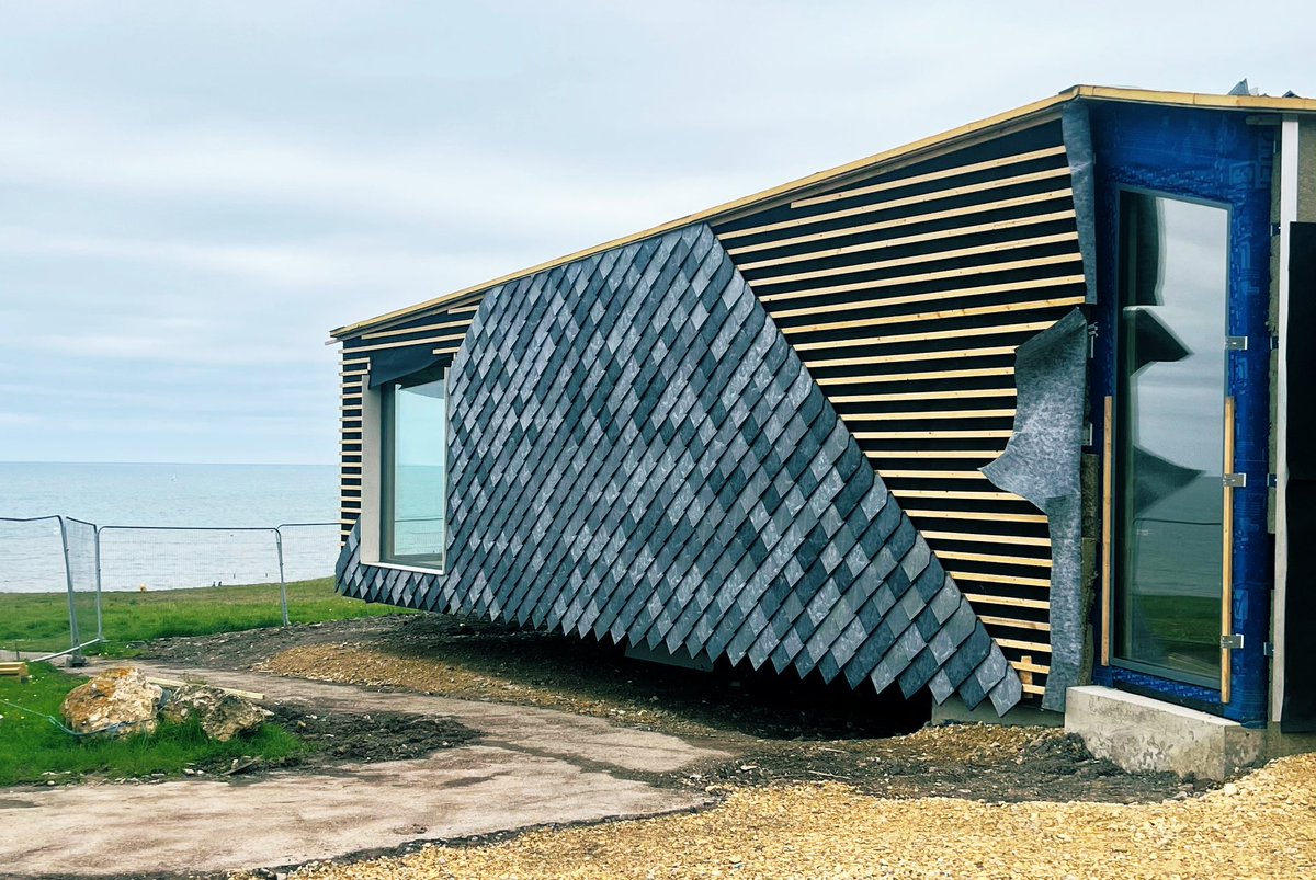 mawsonkerr's tweet photo. Work in progress. Whitburn Coastal Conservation Centre is moving on. Cantilevering out of the bank. The CLT structure is up with the tiles are going on- made from 100% recycled plastic building waste. @SouterNT #Souter #nationaltrust #seascapes @nationaltrust @tynetotees https://t.co/vhh0H0FlrW