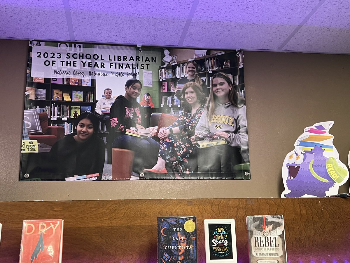 My school wanted me to have an ✨awesome banner✨ to celebrate being named an SLJ #SchoolLibOTY Finalist this year! 🥹 It arrived yesterday and is now displayed in the corner of my library. So grateful for my supportive coworkers - love my building so much 😊💚