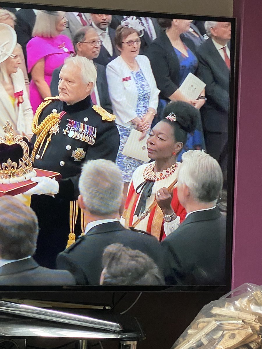 MildlyPod's tweet photo. The King’s crown being flanked by former Play School presenter Floella Benjamin. Rumour has it, had he not died in 2018, it was due to be Geoffrey from Rainbow #CoronationDay #coronation #80sTV https://t.co/4TY6fWc1da