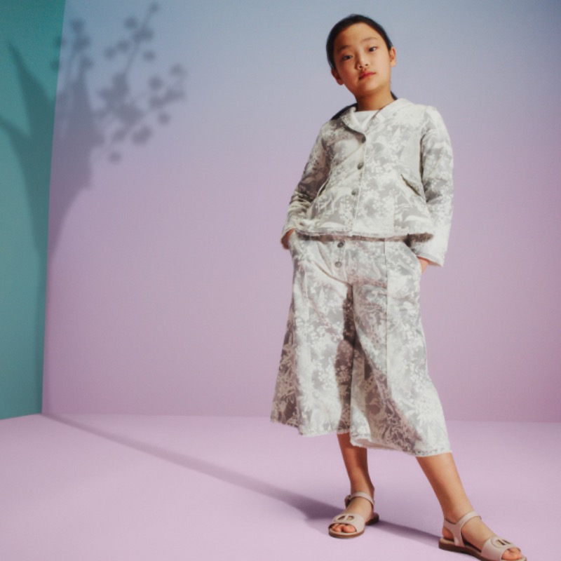 Dior's tweet photo. A sweet ode to the lucky charm lily of the valley. 

Get swept up in the 'White Bell' universe from the latest #BabyDior collection by Cordelia de Castellane with each piece imbued with House codes. Tap on the card for more joyful styles.