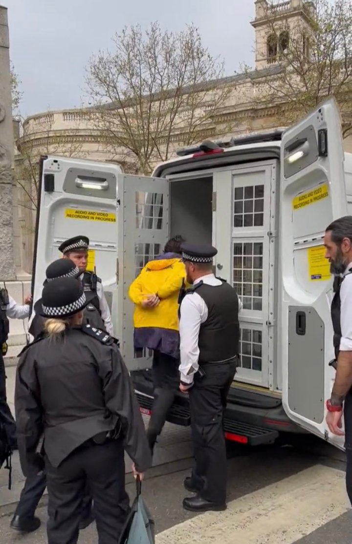 This will be the photo that goes around the world today. A peaceful protester handcuffed and arrested in Britain.