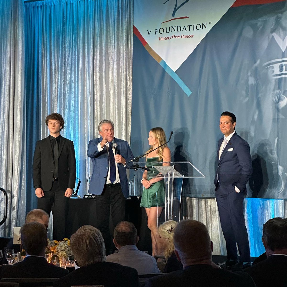MarkBPentecost's tweet photo. Had an awesome time at the V Foundation Gala last night. A new record was set of $12.4 million dollars raised for Pediatric Cancer Research! Glad to be part of such a great cause. We need to find cures for our kids. I appreciate sharing these times with my family, Cindy, my kids, grandkids, and special friends. Very special to share the stage with Sadie and my grandson Landon. Big moments to pass on to future generations, the need to give back and we get to do this. Very blessed. Dick Vitale is a one of kind special man. Well done, Dick!
