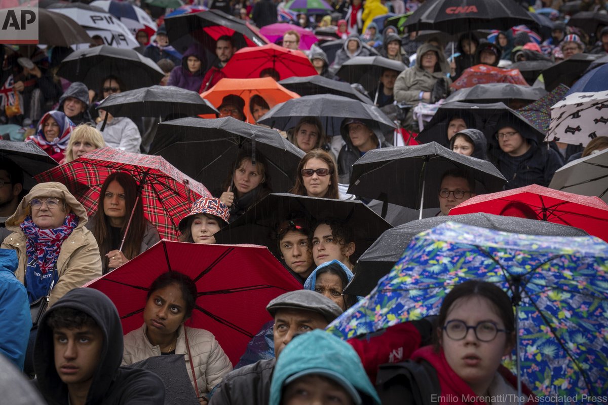 Royal fans watch the Britain's King Charles III coronation ceremony on a screen in Hyde park, in London, Saturday, May 6, 2023.