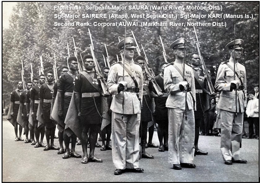 QEII’s Coronation Parade:
The Royal Papua New Guinea Constabulary Contingent await orders to march at Birdcage Walk outside Wellington Barracks.
On a damp London day sandals & groundsheets gave little comfort.
Front: Bill Burns, Peter Broman, 'Sandy” Sinclair.

#PNG #PNGDF #RPNGC