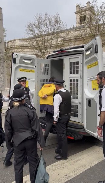 As part of the elaborate coronation ceremony, commoners are escorted by ceremonial guards into a Vauxhall van made specially for the occasion