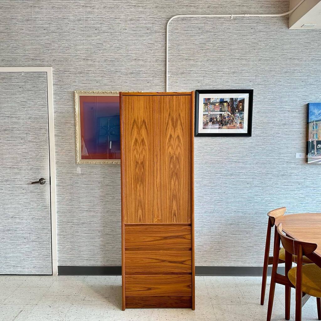 Tall, narrow teak wardrobe. 3 drawers under a door which hides a finished interior and adjustable shelves or take out the shelves and add a hanging bar! 
The grain and colour is exceptional. 
Excellent condition. 

✅ 🇨🇦 wide shipping
✅ Refunds for 7 … instagr.am/p/Cr577l6Av81/