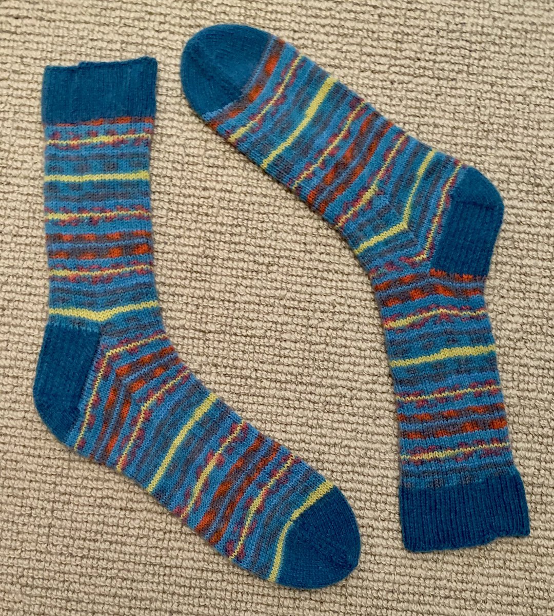 LivRunsFast's tweet photo. Socks for Dad🧦, modelled by partner, and in to the bath. Variation on Nice Ribbed Sock in Regia Design line. Technically, these are the #sockalong ✅ March socks. Estimated delivery time to US between 1 day - 6 months by the time I get them packed and mailed 😬. #KnittingTwitter https://t.co/J3bSR0ziFS