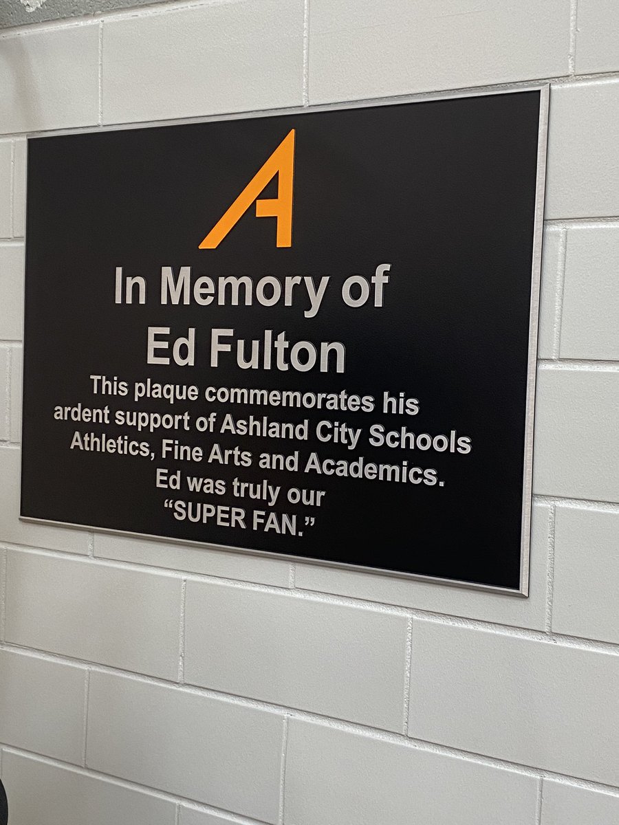 ArrowsBusiness's tweet photo. So proud to have this plaque in Arrow Arena now commemorating one of the greatest Arrows I’ve ever known.  Ed Fulton will live on forever not only in our gym, but in our hearts and lives due to his care, support, and generosity! We miss you every day Ed.  #weareashlandarrows🧡🖤 https://t.co/4xXsm5BDCt