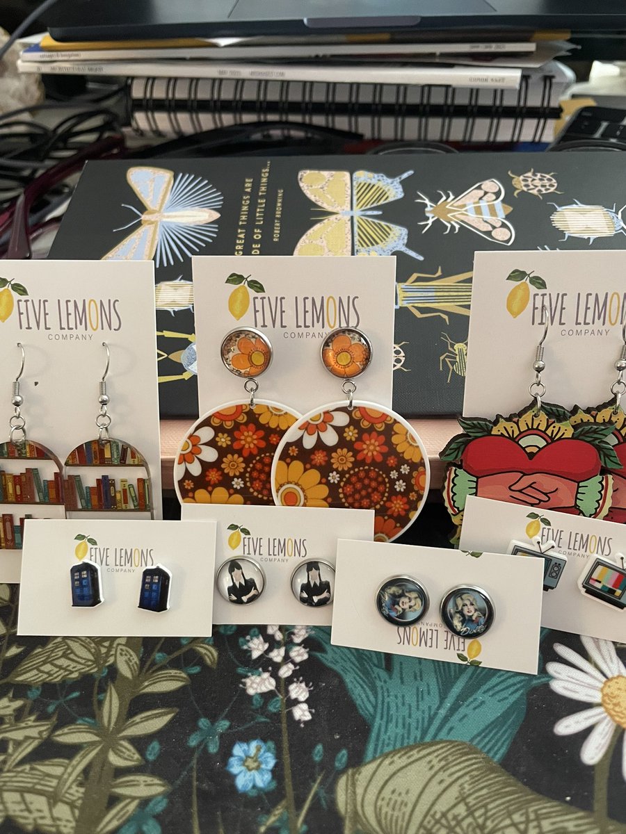 CandaceHavens's tweet photo. In celebration of the An American in Scotland release, I treated myself to a few treasures from @5LemonsCompany I may have been a bit greedy. But I love them all. Mine. Mine. #earrings #books #wednesdayaddams #tardis #dollyparton #mysterynovels https://t.co/DwOgaJLvDc