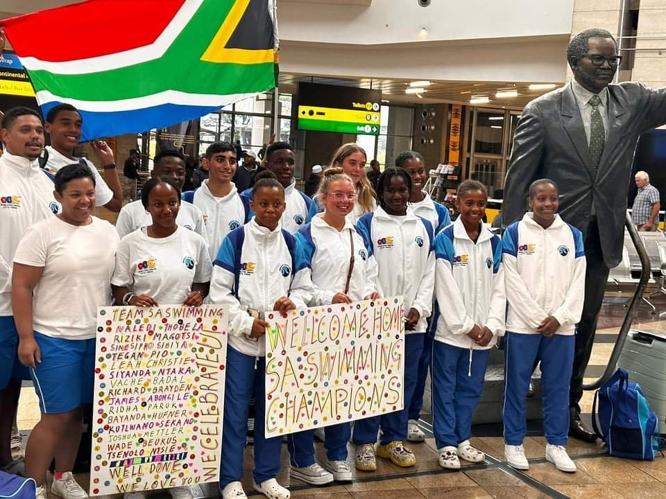 SwimSouthAfrica's tweet photo. Swimmers welcomed back home from the 19th Cana Zone IV champs #family #swimmerslife #champsinthemaking https://t.co/YO7PDSHTov