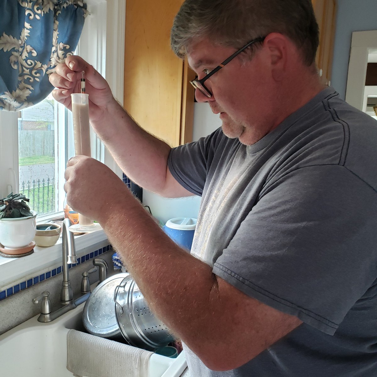 EngineerdSpirit's tweet photo. James Moore just added some yeast to his #JimmyRedcorn beer mix. Before he puts it in to ferment, he does a quick test of its alcohol potential using a Brix hydrometer, which measures sugar content. At 7%, which is higher than usual, we’re right where we want to be at this stage. https://t.co/NZaAbMKrRv