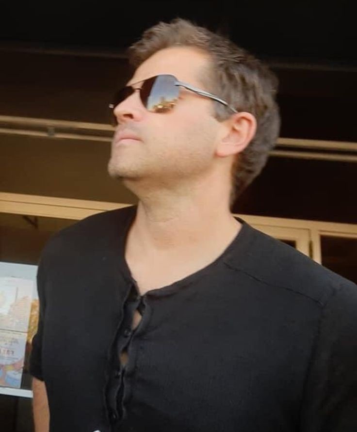 Thinking about him wearing this top because those buttons are straining