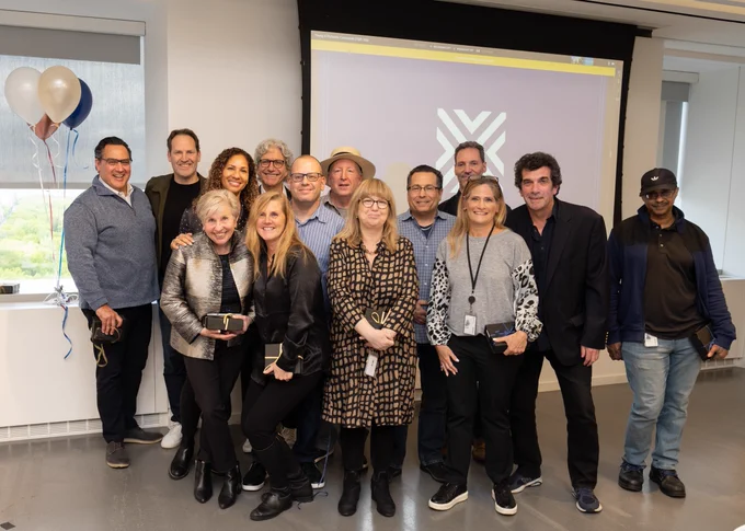 A group of VMLY&R employees standing together posing for a photo.