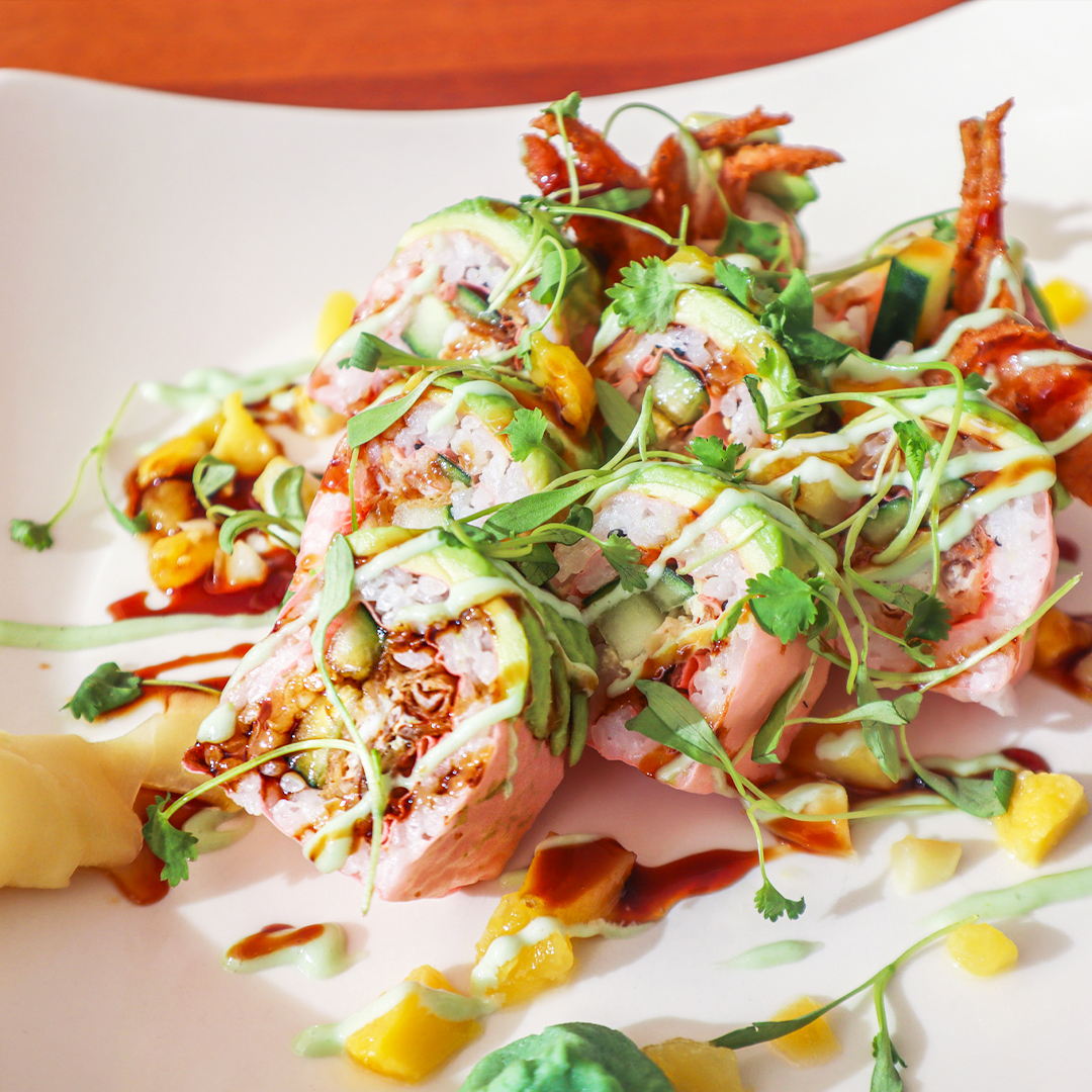 Tempura fried softshell crab, cucumber, and avocado are wrapped in soy paper and sushi rice and topped with diced mango, honey wasabi, eel sauce, and micro greens to make our new 𝐆𝐨𝐥𝐝𝐞𝐧 𝐒𝐩𝐢𝐝𝐞𝐫 𝐑𝐨𝐥𝐥 worthy of your chopsticks' attention! 🥢